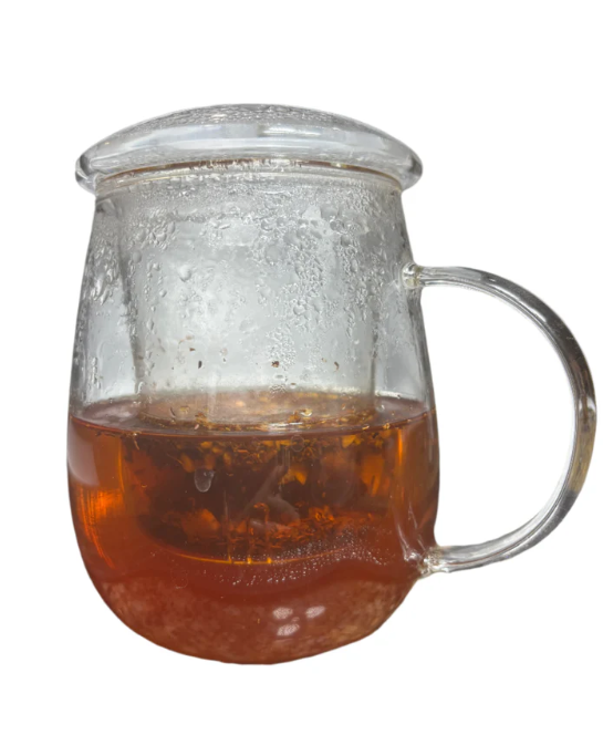 African Sunrise herbal tea steeped in a glass teapot with warm amber tones.