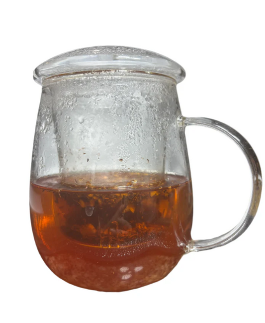 African Sunrise herbal tea steeped in a glass teapot with warm amber tones.