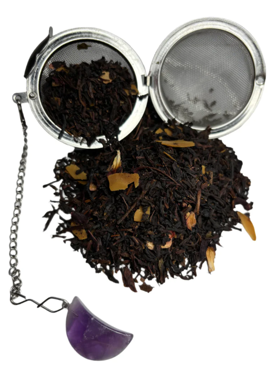 Loose black tea leaves in a metal tea infuser used for culinary applications