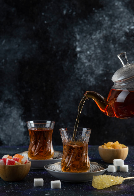 Clear glass mug filled with dark brewed flavored black tea.