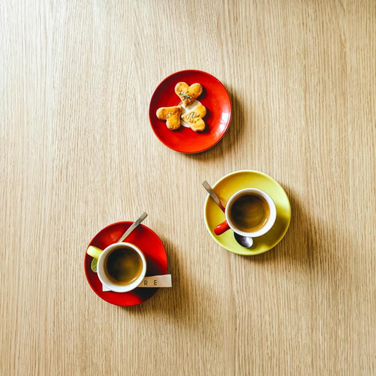 Two ceramic mugs with steaming tea placed on saucers, showcasing the perfect tea and spice pairing experience.