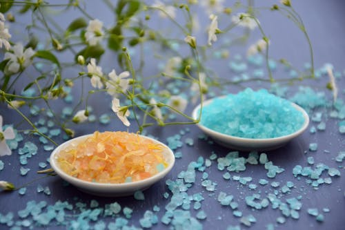 Blue and yellow Greek salts displayed separately in a bowl. 