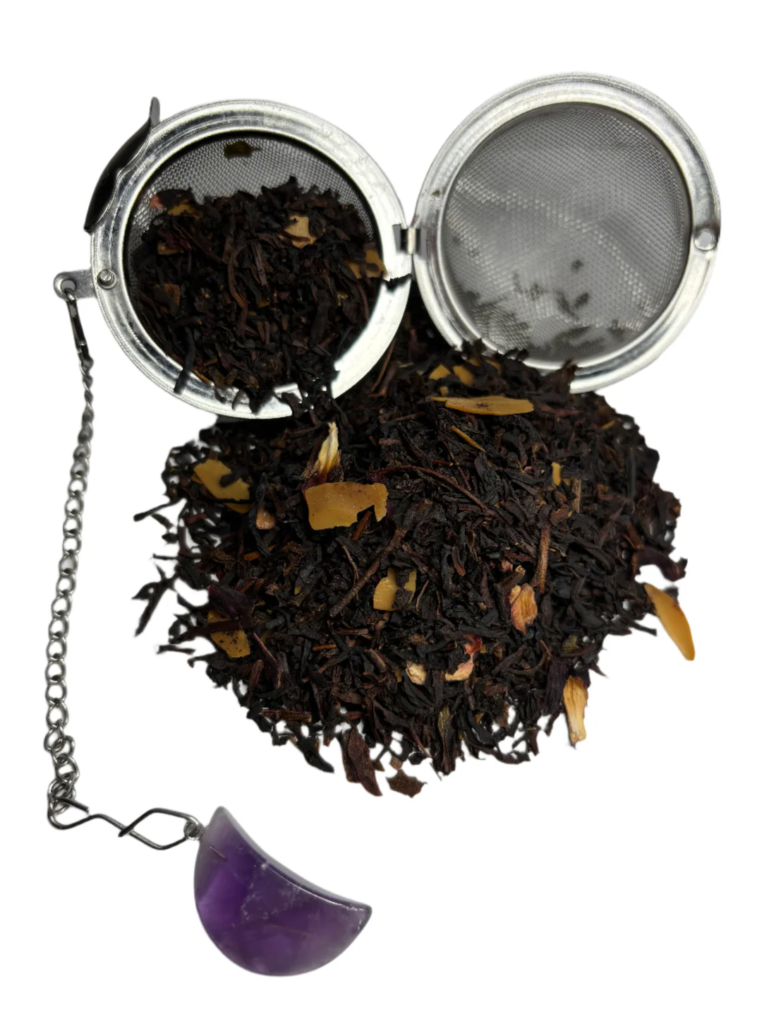 an open sieve with loose leaves of tea around it.