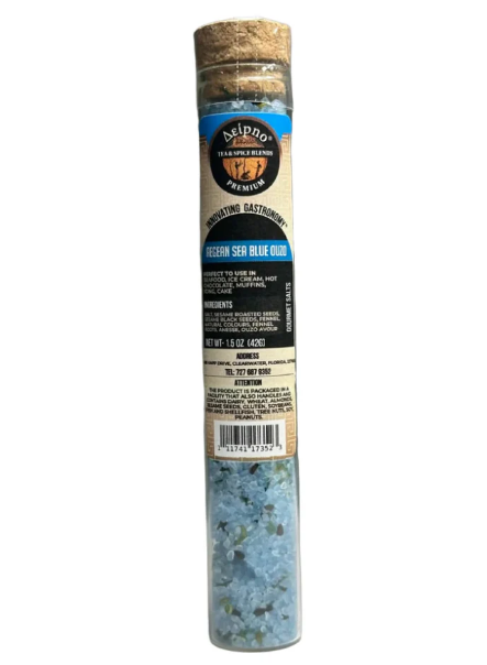 A tall glass vial filled with blue salt crystals and sealed with a cork, featuring a beige and blue product label.