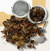Loose-leaf tea blend scattered beside an open metal tea infuser.